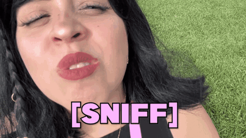 A Woman Blowing A Kiss With The Word Sniff Written In Pink GIF
