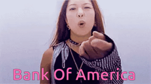 A Woman Blows A Kiss In Front Of A Bank Of America Logo GIF