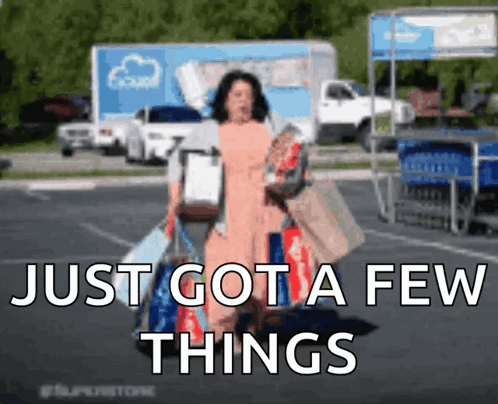A Woman Carrying Shopping Bags In A Parking Lot With The Words Just Got A Few Things Above Her GIF