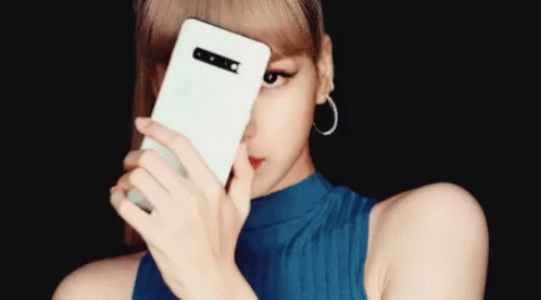 A Woman Covering Her Face With A White Phone GIF