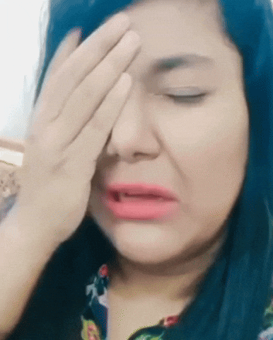 A Woman Covering Her Face With Her Hand And Making A Funny Face GIF