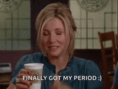 A Woman Covering Her Face With Her Hand While Holding A Cup Of Coffee And Saying Finally Got My Period . GIF