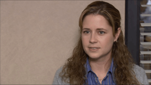 A Woman Covering Her Face With Her Hand While Looking Down GIF