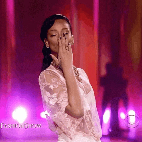 A Woman Covering Her Face With Her Hand While Wearing A White Lace Top With The Words Fashion Show On The Bottom GIF