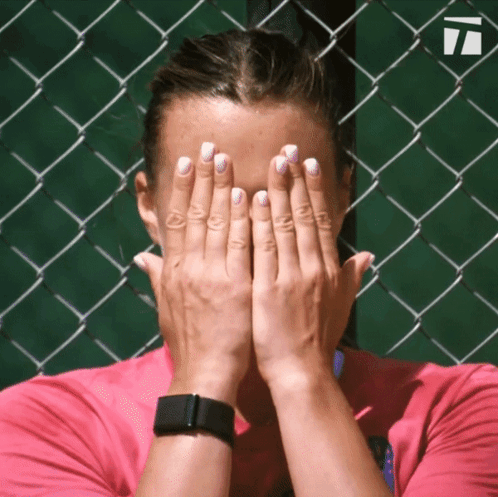A Woman Covering Her Face With Her Hands While Wearing A Smart Watch GIF