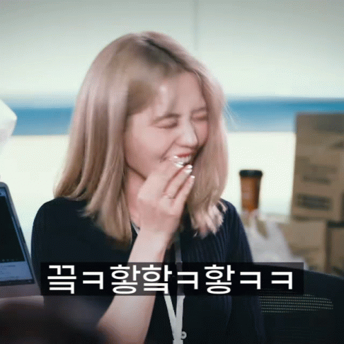 A Woman Covering Her Mouth With Her Hand And A Sticker That Says V On It GIF