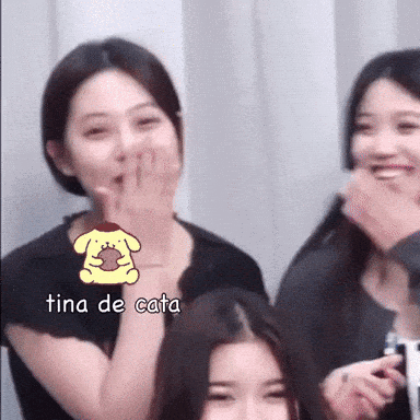 A Woman Covering Her Mouth With Her Hand And The Word Tina De Cata Is On The Bottom GIF