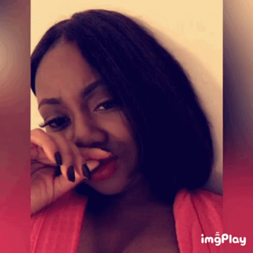 A Woman Covering Her Nose With Her Hand And A Red Background With Imgplay At The Bottom GIF