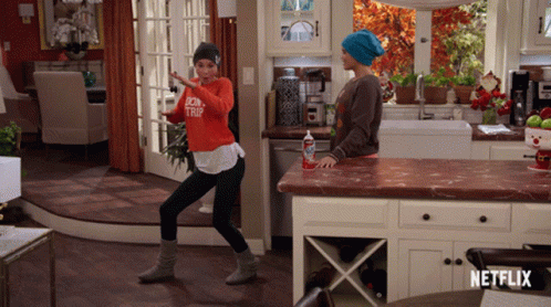 Woman Dancing In Kitchen With Netflix Logo GIF