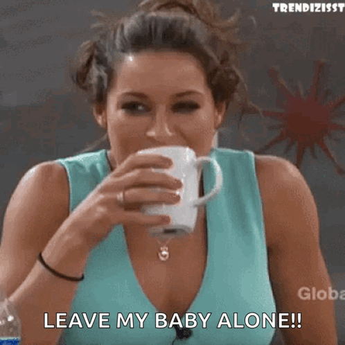 A Woman Drinking A Cup Of Coffee And Saying Leave My Baby Alone .. GIF