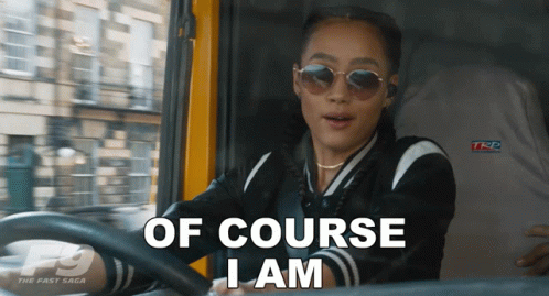 A Woman Driving A Car With The Words Of Course I Am On The Screen GIF