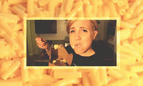 A Woman Eating Macaroni And Cheese With A Fork GIF