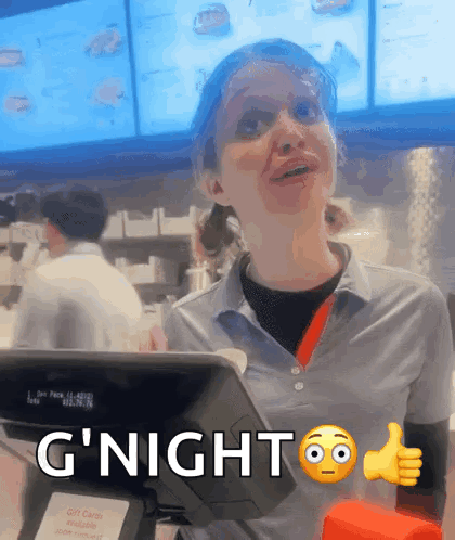 A Woman Giving A Thumbs Up Next To A Sign That Says G Night GIF