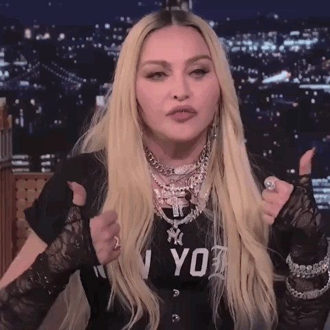 A Woman Giving A Thumbs Up Wearing A Black Shirt That Says Ny On It GIF