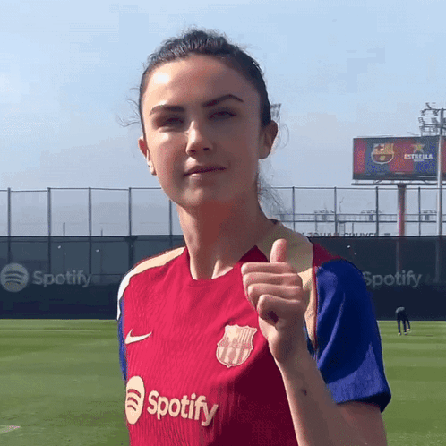A Woman Giving A Thumbs Up Wearing A Spotify Shirt GIF