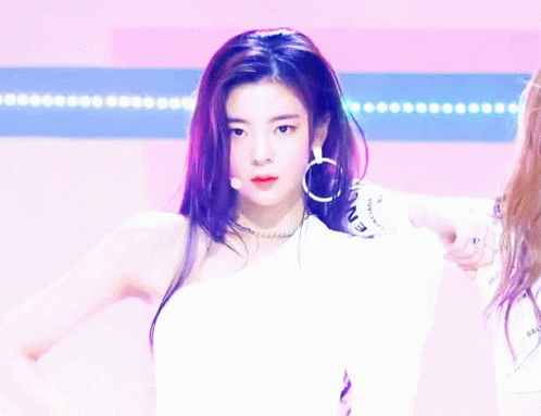 A Woman Giving A Thumbs Up While Wearing A White Shirt That Says Icon GIF