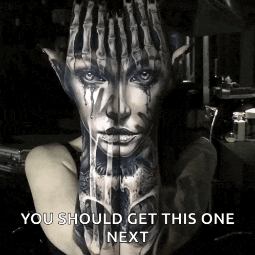 A Woman Has A Tattoo Of A Woman 'S Face On Her Arm GIF