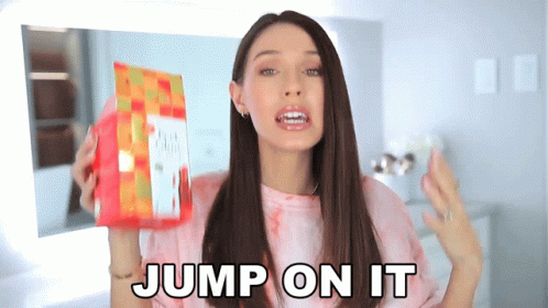 A Woman Holding A Bag Of Food With The Words Jump On It Behind Her GIF