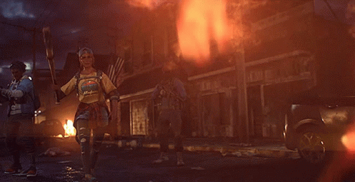 A Woman Holding A Bat And Wearing A T-Shirt That Says ' I 'M A Hippie ' GIF
