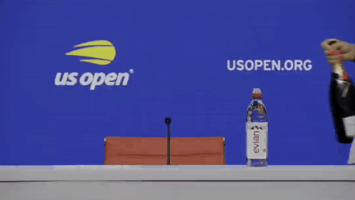 a woman holding a bottle of evian water and a bottle of champagne