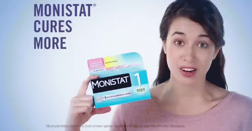A Woman Holding A Box Of Monistat Pills GIF