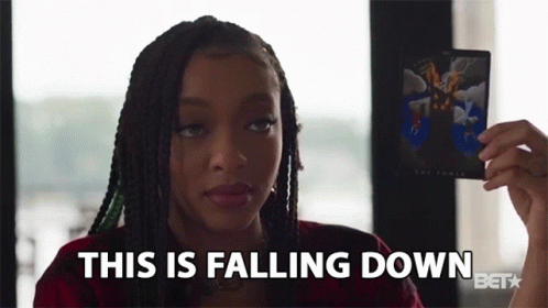 a woman holding a card that says this is falling down