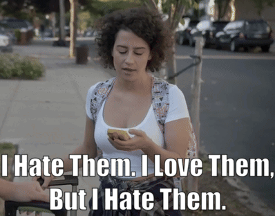 A Woman Holding A Cell Phone With The Words " I Hate Them I Love Them But I Hate Them " On The Bottom GIF