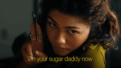 A Woman Holding A Cell Phone With The Words " I 'M Your Sugar Daddy Now " Above Her GIF