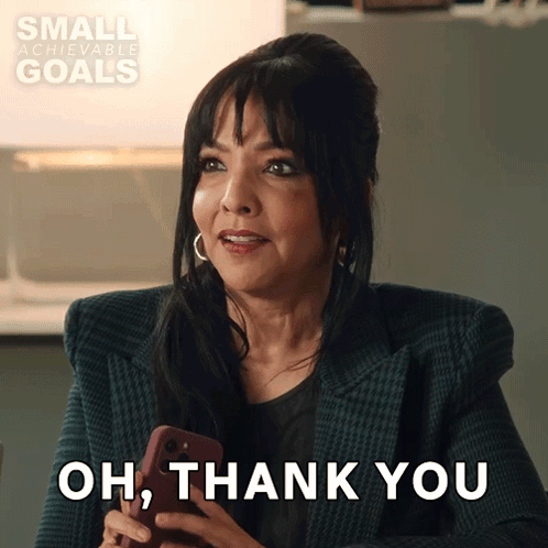 A Woman Holding A Cell Phone With The Words Oh Thank You Behind Her GIF