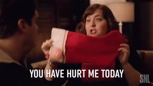 A Woman Holding A Christmas Stocking With The Words You Have Hurt Me Today GIF