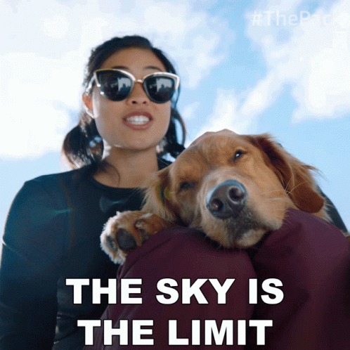 A Woman Holding A Dog With The Words The Sky Is The Limit GIF