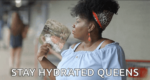 A Woman Holding A Fan With The Words Stay Hydrated Queens Written Below Her GIF
