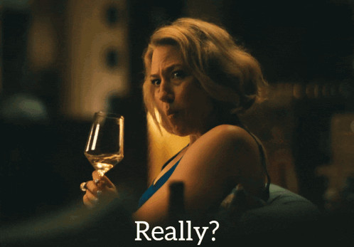 a woman holding a glass of wine with the word really behind her