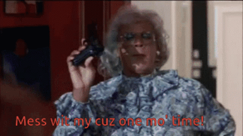 A Woman Holding A Gun With Mess Wit My Cuz One Mo Time Written In Red GIF