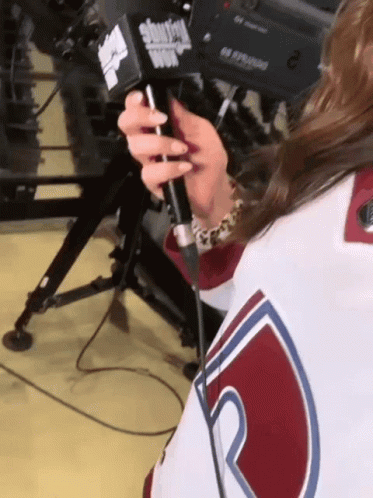 A Woman Holding A Microphone That Says Showtime GIF