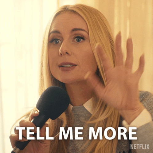 A Woman Holding A Microphone With The Words Tell Me More On The Bottom Right GIF