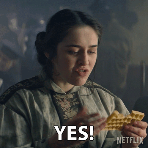 A Woman Holding A Piece Of Food With The Word Yes Written On It GIF