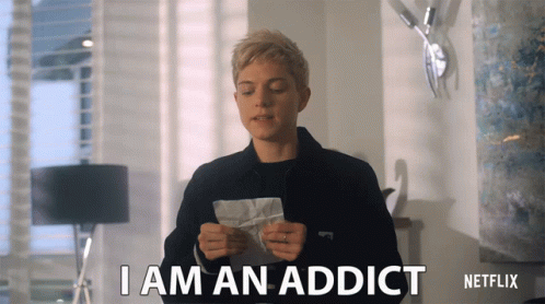A Woman Holding A Piece Of Paper That Says I Am An Addict On It GIF
