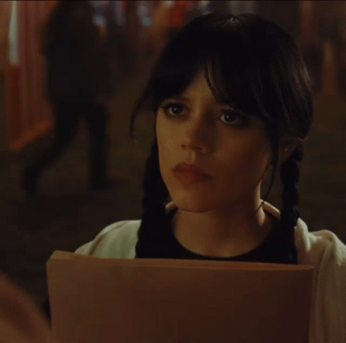 A Woman Holding A Piece Of Paper That Says " I Prefer Spooky " GIF