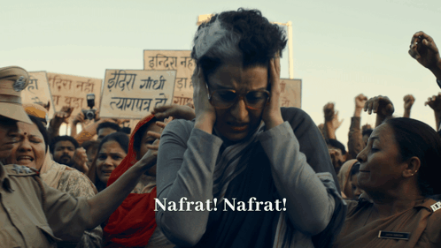 A Woman Holding A Sign That Says Nafrat Is Surrounded By Protesters GIF