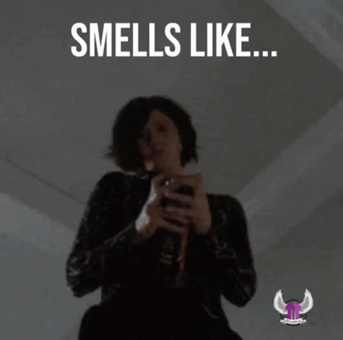 A Woman Holding A Spray Can With The Words Smells Like Lies Below Her GIF