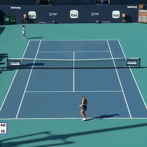 a woman holding a tennis racquet in front of a lex clock