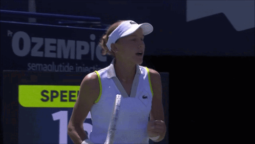 A Woman Holding A Tennis Racquet In Front Of A Scoreboard That Says Spee GIF