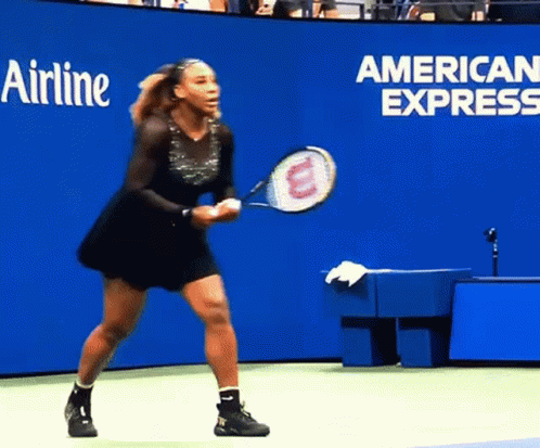 A Woman Holding A Tennis Racquet In Front Of A Wall That Says Airline GIF