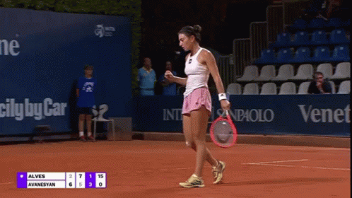 A Woman Holding A Tennis Racquet On A Court With A Scoreboard That Says Alves Ayanesyan GIF