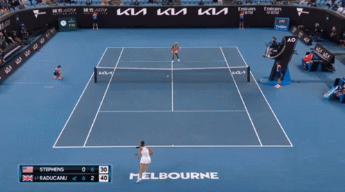 A Woman Holding A Tennis Racquet On A Tennis Court In Front Of A Kia Ad GIF