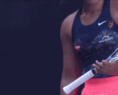 A Woman Holding A Tennis Racquet That Says Workday GIF