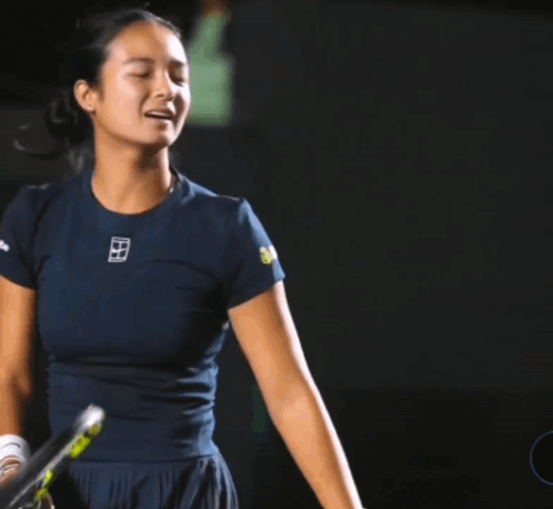 A Woman Holding A Tennis Racquet With A Shirt That Says ' Nike ' On It GIF