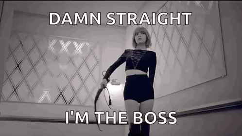 A Woman Holding A Whip With The Words " Damn Straight I 'M The Boss " Below Her GIF