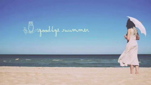 A Woman Holding An Umbrella On The Beach With The Words " Goodbye Summer " Written In The Sky GIF